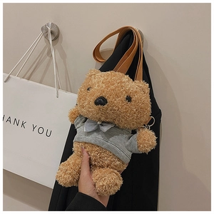 Detail of cute brown plush bear crossbody bag with a grey hoodie and ribbon bow
