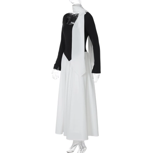 Detail view of contrast long-sleeve dress featuring black bodice and white flowing skirt