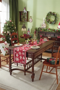 Close-up of red Christmas table runner with white snowflake patterns and elegant tassels