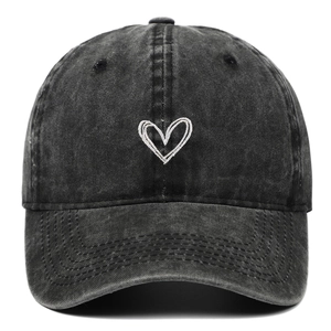 Detail of white heart embroidery on washed black vintage cotton baseball cap