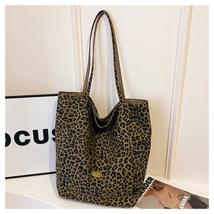 Close-up of leopard print tote bag with metal logo detail and large capacity canvas