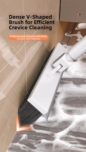 Detail of V-shaped bristles cleaning bathroom tile gaps with white cleaning foam