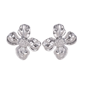 Macro detail of silver sunflower earrings featuring polished steel petals and floral design