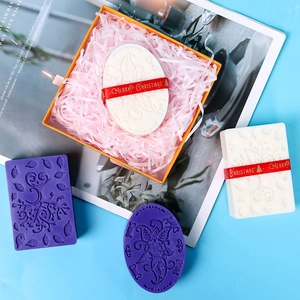 Detail of Christmas handmade soap gift set with ethnic floral patterns and festive ribbons