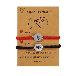Adjustable woven bracelet set with stainless steel spider and web pendants on card