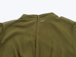 Detail view of the army green chiffon dress featuring a concealed back zipper closure