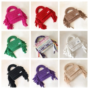 Nine color variants of handmade crochet crossbody bags with decorative tassels