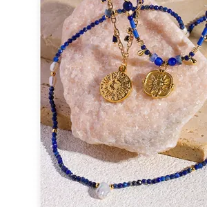 Lapis lazuli beaded necklace with gold sun pendant and baroque pearl accents