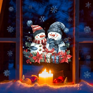 Christmas window static stickers featuring snowmen and snowflakes in a cozy indoor scene