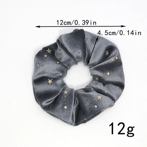 Detail of grey velvet scrunchie with gold stars showing 12cm diameter and 4.5cm width