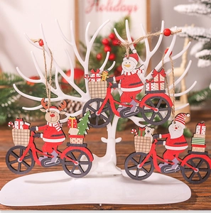 Detailed view of wood Christmas ornaments featuring Santa and snowman on a bicycle