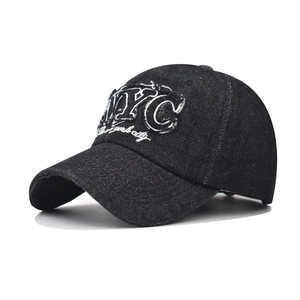 Detailed close-up of retro washed denim baseball cap with NYC embroidery and frayed edges