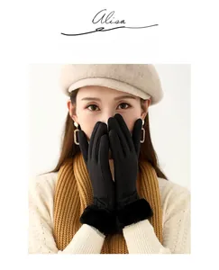 Detail of black thermal gloves with plush faux fur cuffs on a winter model outfit
