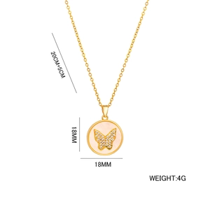 Gold butterfly pendant necklace with mother of pearl and zircons on white background