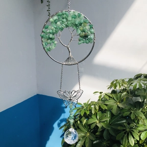 Detail of tree of life suncatcher with green stones and clear crystal prism ball