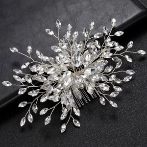 Elegant silver bridal hair comb with marquise crystals on a black leather surface