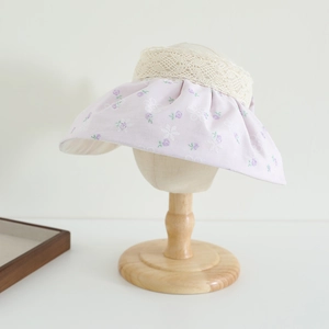 Detail of lavender floral sun hat with exquisite beige lace trim on fabric shell brim