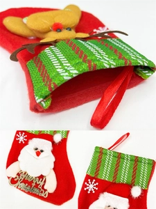 Detail of red felt Christmas stocking featuring 3D Santa, reindeer, and Merry Christmas sign