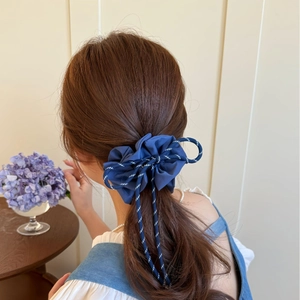 Navy blue plaid bow hair scrunchie with drawstring cords on a model's ponytail