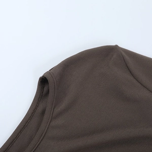 Macro shot of dark brown ribbed knit fabric showing collar stitching and shoulder seam detail