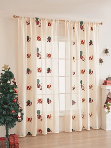 Detail of Christmas lace curtain with Santa Claus embroidery and festive red sled pattern