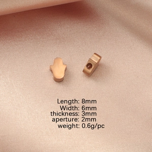 Rose gold Hamsa Hand charm details with size measurements: 8mm length and 2mm aperture