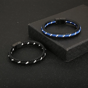 Detail of two braided leather bracelets with colorful accents and magnetic clasps