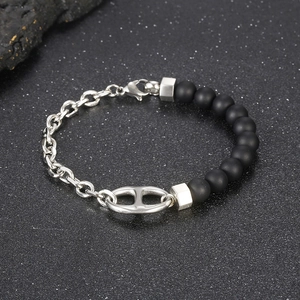 Detailed close-up of pig nose link bracelet with black onyx beads and silver chain