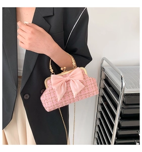 Détail du sac à main en tweed rose avec nœud en soie et poignée en métal doré rétro