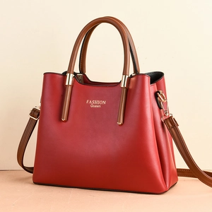 Red leather handbag with brown handles and Fashion Queen text in a 45-degree view