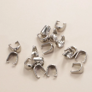 Macro detail of silver stainless steel pinch bails for DIY jewelry making pendants