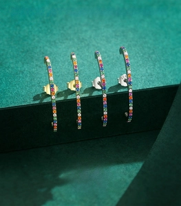 Detailed view of s925 sterling silver C-shaped earrings with rainbow colored gemstones