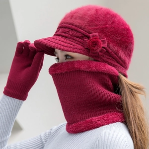 Detail of red winter knit hat with floral trim and plush faux fur lining scarf