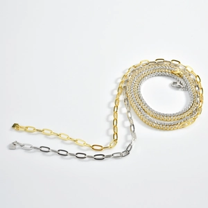 Detail view of gold and silver S925 sterling silver paperclip and tennis chain necklaces