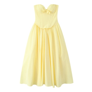 Detail of a pastel yellow strapless corset maxi dress with a delicate front bow