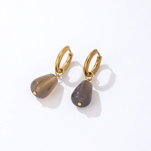 Detail of minimalist gold drop earrings with dark grey translucent teardrop stones