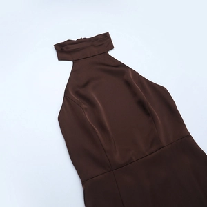 Detail of dark brown satin dress showing halter neck design and silky fabric texture