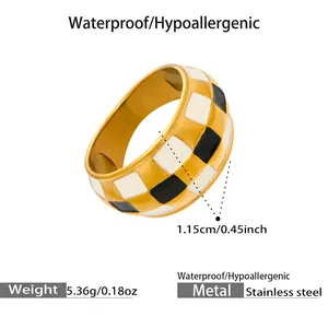 Detail showing checkered enamel pattern on a 18k gold plated wide stainless steel ring