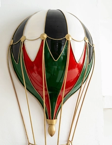Close-up of French retro hot air balloon wall decor with red, green, and black panels