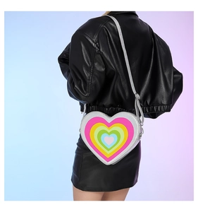 Rainbow heart cross-body bag on model wearing a black leather jacket for a stylish look