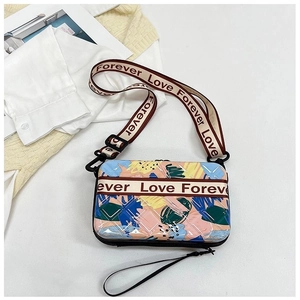 Détail du sac bandoulière abstrait coloré avec sangle Forever Love sur fond blanc