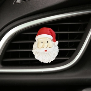 Detail of Santa Claus car air vent clip with red hat and white beard decoration