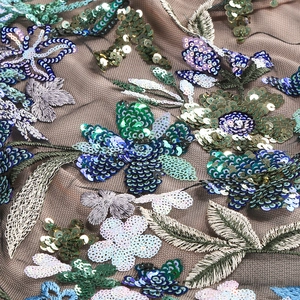 Macro detail of intricate floral sequin embroidery on mesh for halter slim dress