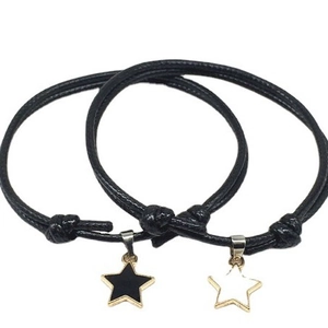 Adjustable black wax cord bracelets with gold star pendants for men and women