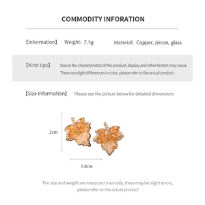 Detail view of 14k gold plated maple leaf earrings with dimensions and copper material specs