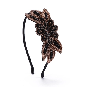 Detail of bohemian headband with bronze and black beaded leaf pattern rhinestones