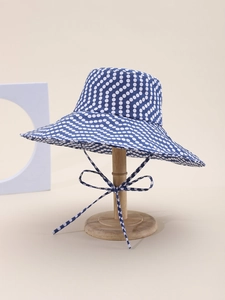 Blue and white polka dot cotton sun hat with wide brim and adjustable chin strap bow