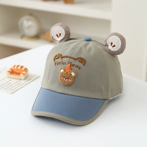 Close-up of cartoon bear embroidery and 3D ears on a toddler baseball sun hat