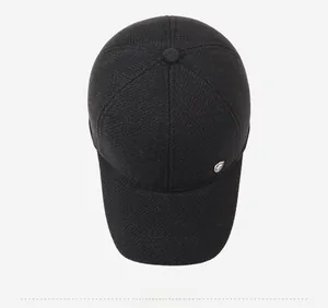 Top view of deep black winter baseball cap with textured fabric and metal logo detail