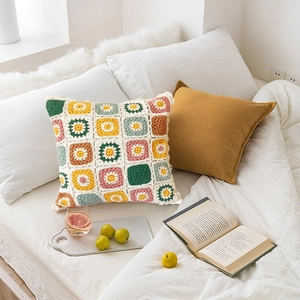 Handmade crochet granny square pillow cover with colorful floral patterns for home decor